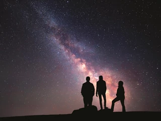 Milky Way. Night sky and silhouette of a family