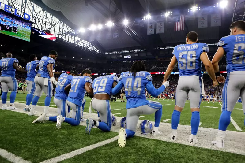 Zawodnicy Detroit Lions klęczą na murawie podczas odgrywania hymnu USA - 24.09.2017