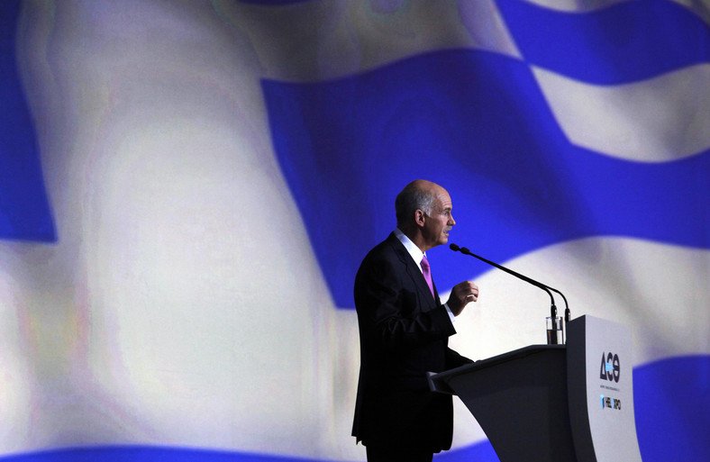 Obecny premier Grecji Jorgos Papandreu na tle greckiej flagi.