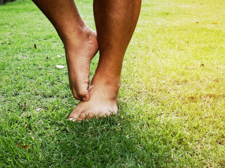 Itching caused by foot fungi on the grbad in the park. 