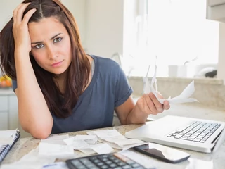 Young woman looking worried over finances