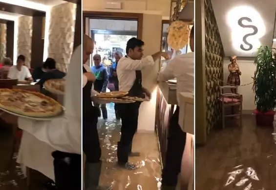 Tłum ludzi w zalanej restauracji w Wenecji. Klienci jedzą pizzę w kaloszach