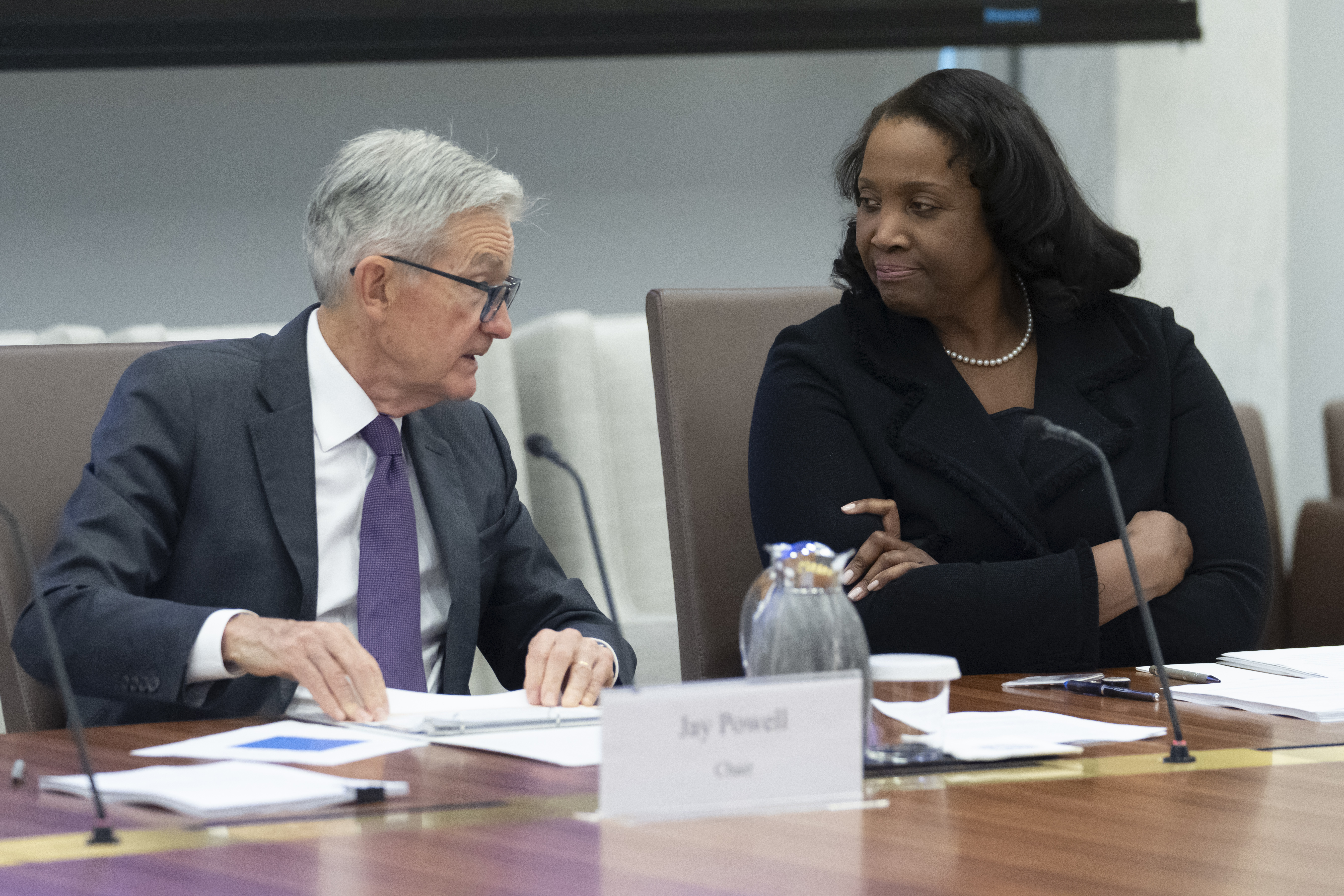 Federal Reserve Chair Jerome Powell (left), talks with Board of Governors member Lisa Cook during an open meeting of the Board of Governors at the Federal Reserve on June 25, 2025, in Washington.