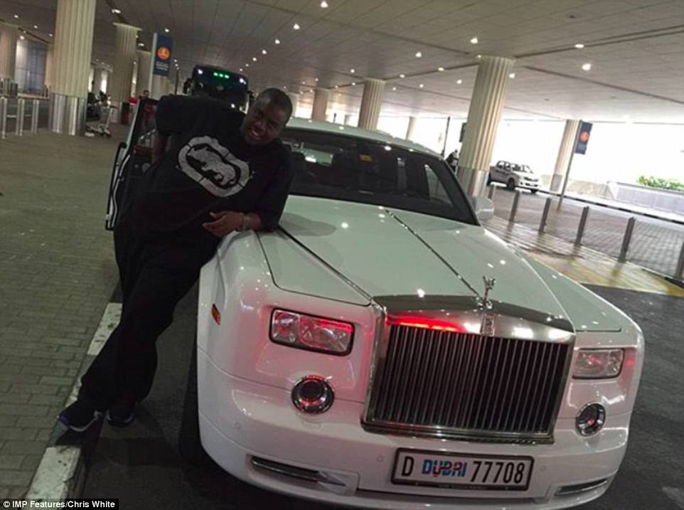Late Zimbabwean businessman Wicknell Chivayo poses beside a white Rolls-Royce Phantom. He was known for his extensive collection of luxury vehicles. Source: Business Daily Zimbabwe.
