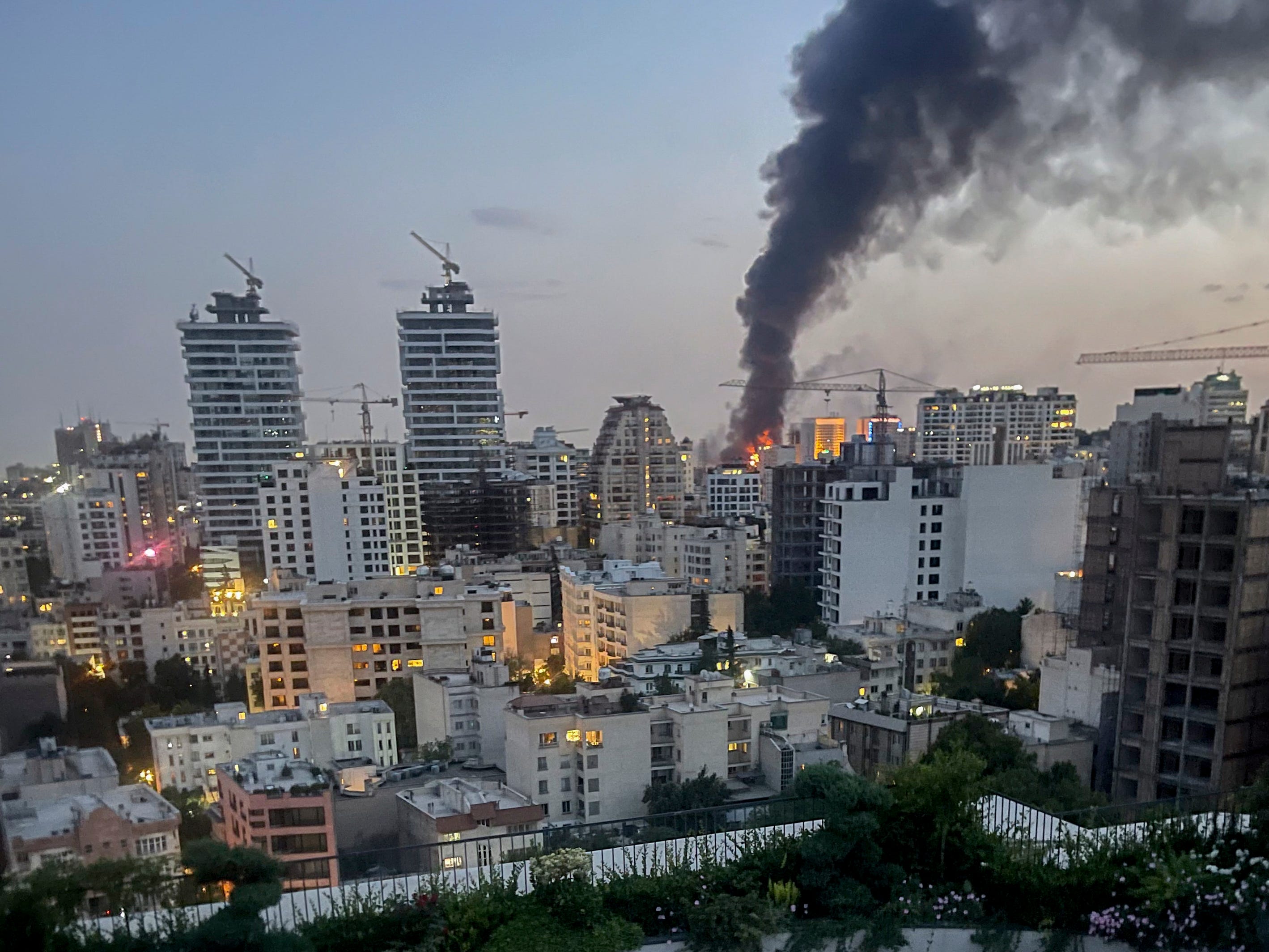 Smoke rises from the rubble of an Iranian state media building in Tehran after an Israeli airstrike on June 16.Mina/Middle East Images/AFP/Getty Images
