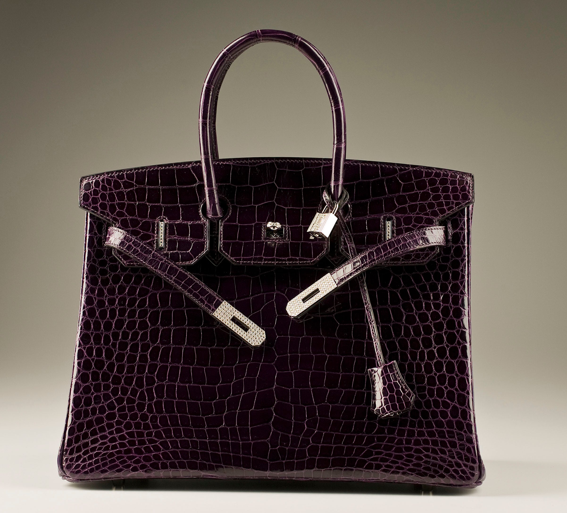 A gold and diamond-encrusted Hermès Birkin bag containing 9
