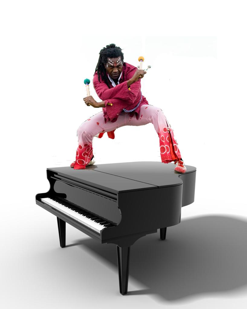 Amayo posing on a Grand Piano