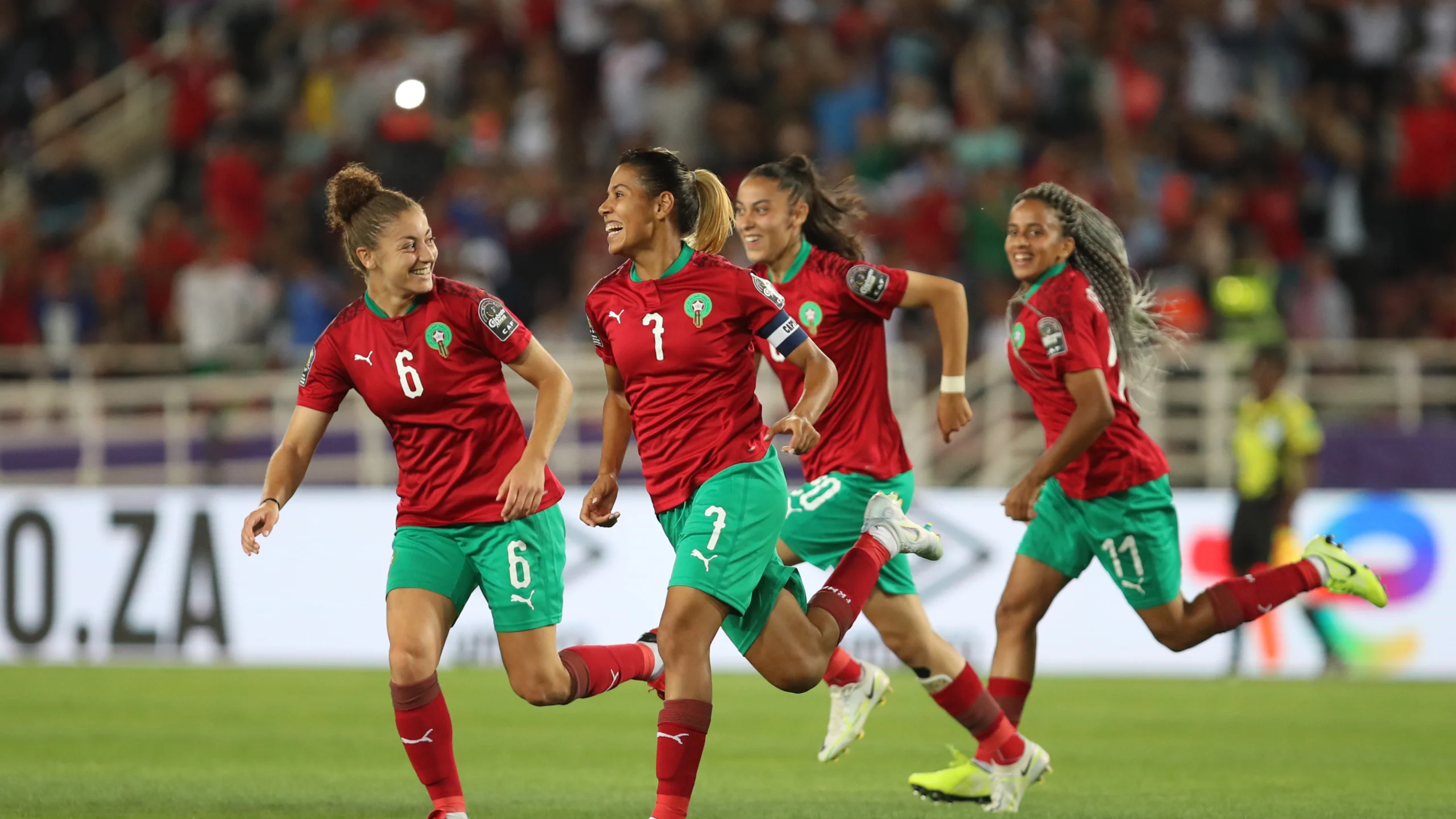 Morocco's captain Ghizlane Chebbak celebrates with her teammates after scoring a free-kick