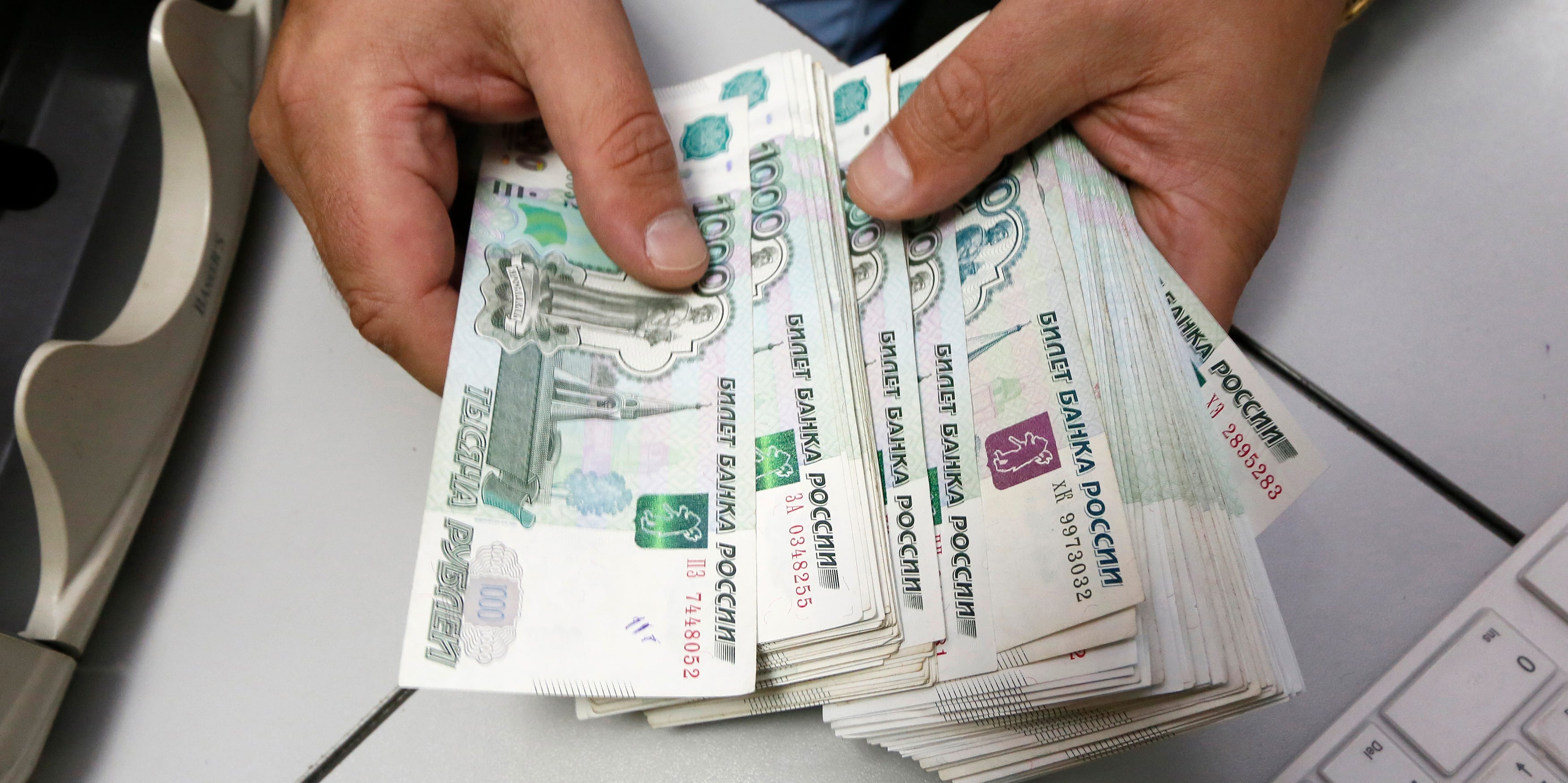 REUTERS/Ilya NaymushinAn employee counts Russian ruble banknotes at a private company's office in Krasnoyarsk, Siberia, December 17, 2014