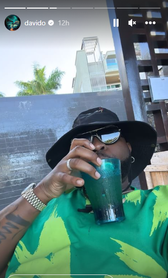 Davido taking a sip of his juice [Instagram/Davido]