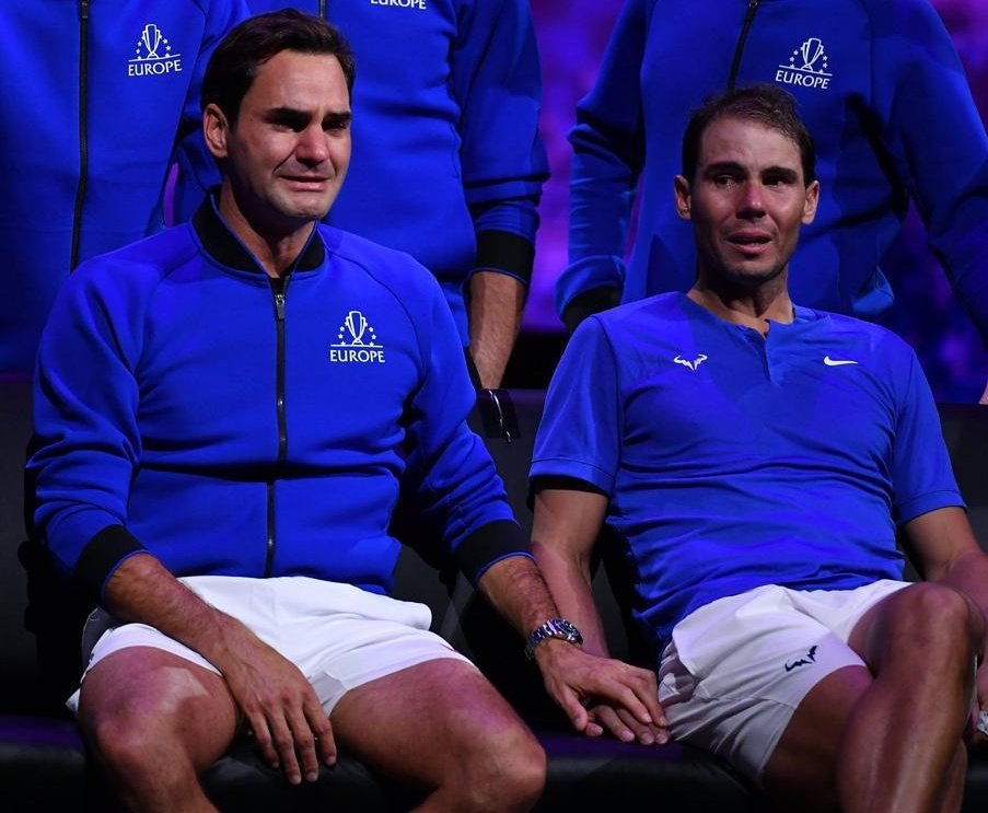 Roger Federer and Rafa Nadal crying while holding hands together at Federer's farewell