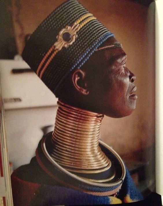 A woman of the South Ndebele tribe wearing metal neck rings [Pinterest]