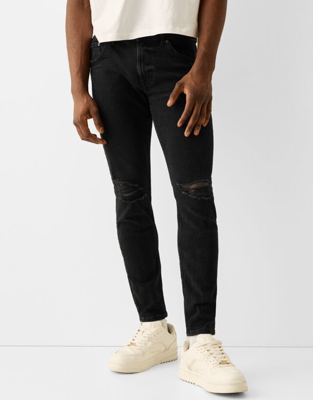 Bershka Jeansy O Kroju Skinny Z Efektem Podarcia Mężczyzna 46 Czarny