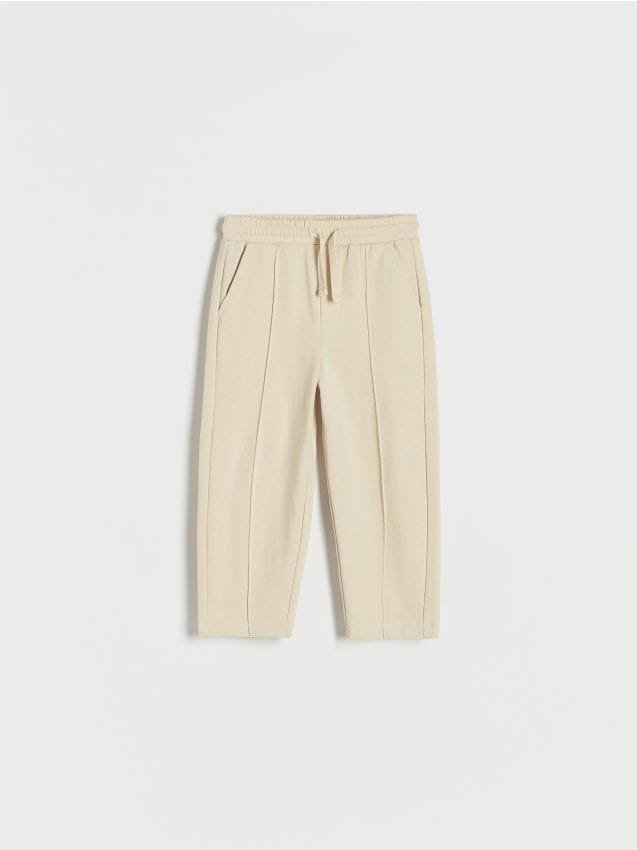 Reserved - Dresowe spodnie z przeszyciami - kremowy