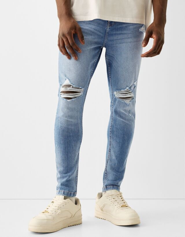 Bershka Jeansy Carrot Fit Z Przetarciami Mężczyzna 48 Wyblakły Niebieski