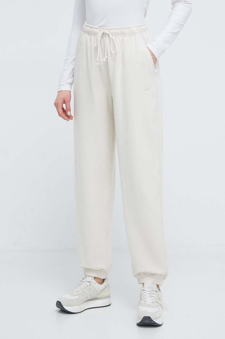 New Balance spodnie dresowe bawełniane WP41513LIN kolor beżowy gładkie