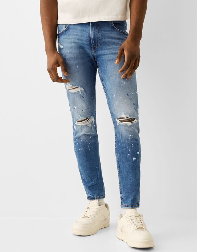 Bershka Jeansy Skinny Z Przetarciami I Plamami Farby Mężczyzna 48 Niebieski