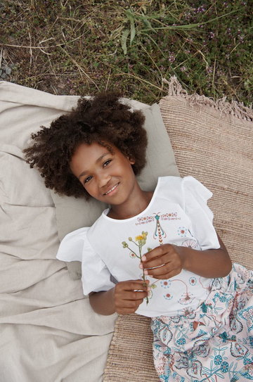 Reima bluzka bawełniana dziecięca kolor biały z nadrukiem