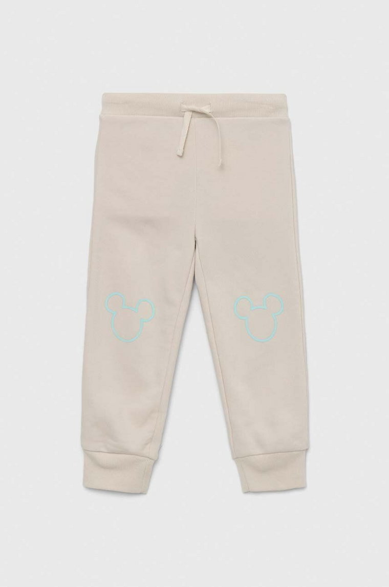GAP spodnie dresowe dziecięce x Disney kolor beżowy z nadrukiem