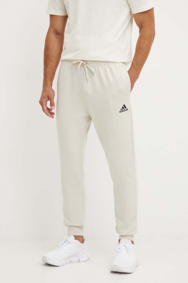 adidas spodnie dresowe Essentials kolor beżowy gładkie JH1039