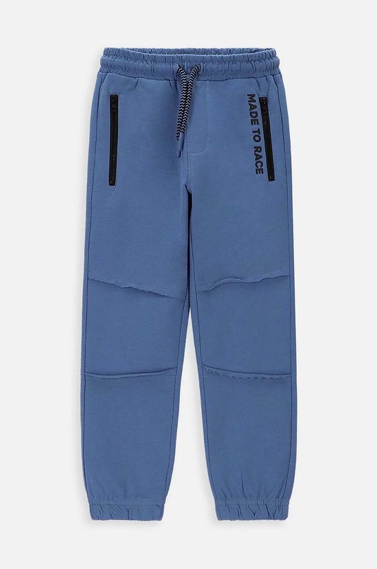 Coccodrillo spodnie dresowe bawełniane dziecięce kolor niebieski z nadrukiem