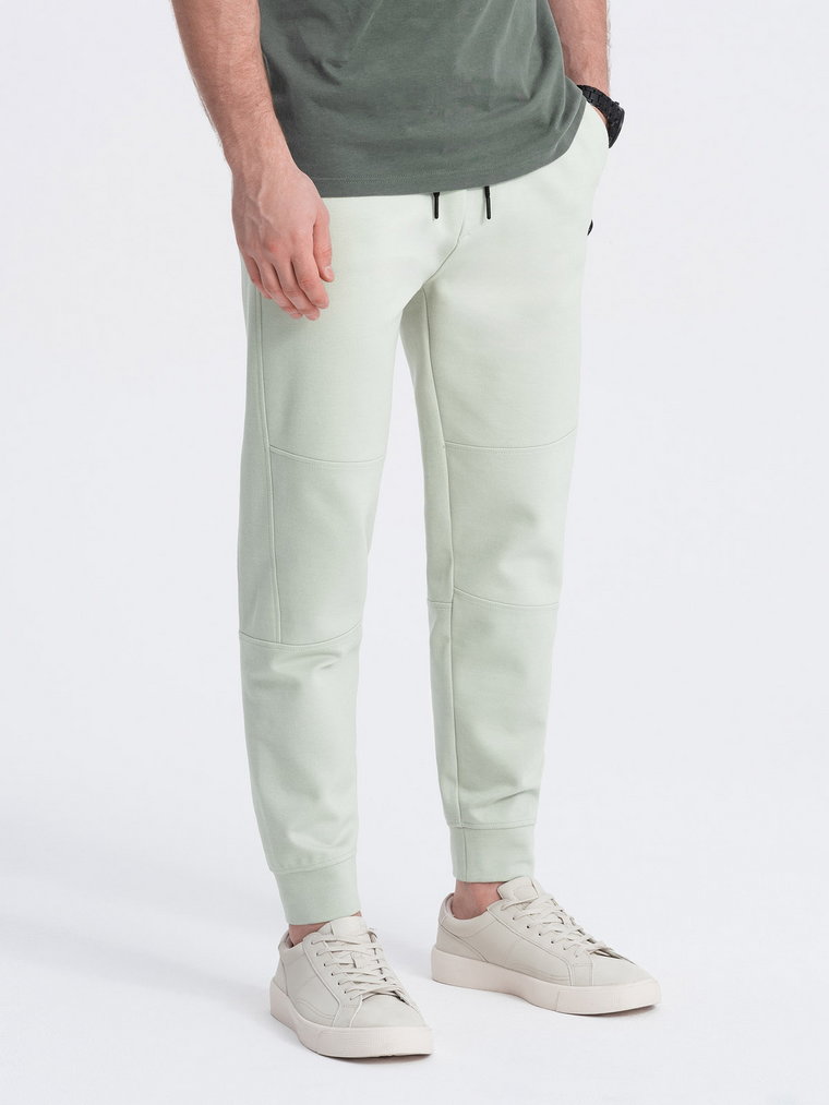 Męskie spodnie joggery dresowe na gumce z przeszyciami  miętowe V3 OM-PASK-0142