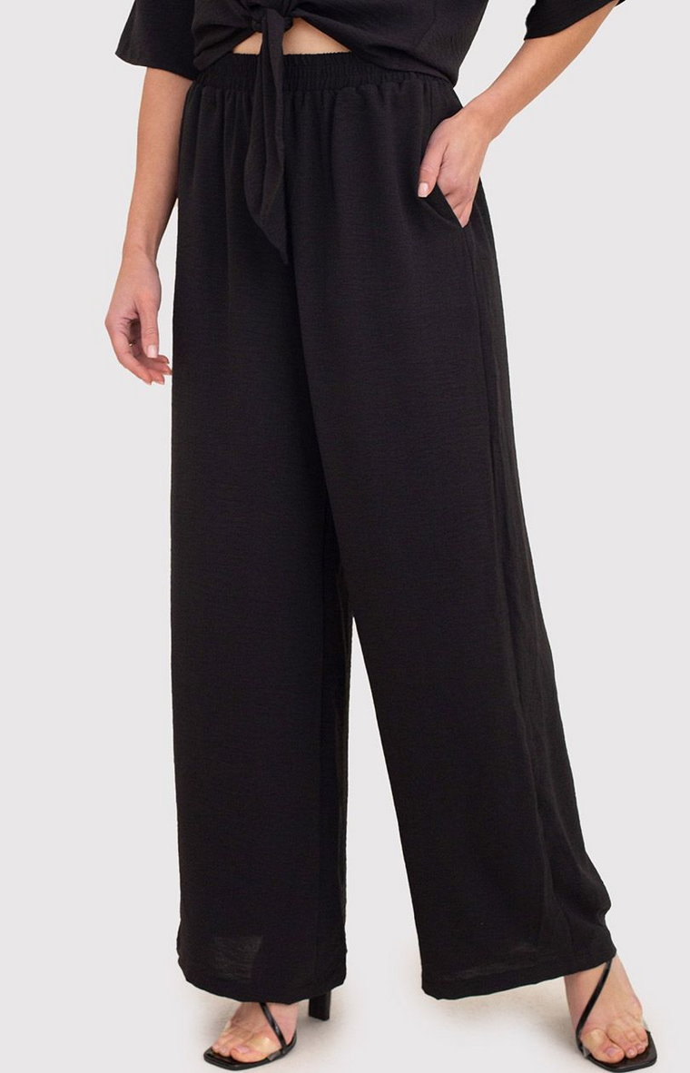 Czarne spodnie z szerokimi nogawkami i elastyczną talią TRA038, Kolor czarny, Rozmiar L, AX Paris