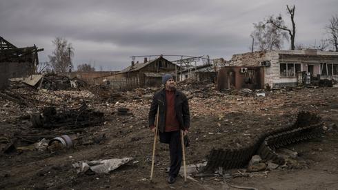 Житель Тросцянця стоїть біля частини знищеного російського танка. Місто нещодавно відбили з рук / фото: AP, East News.