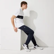 Spodenki męskie - Lacoste męskie spodnie sportowe ze wstawkami z siatki - miniaturka - grafika 1