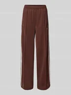 Spodnie sportowe damskie - Spodnie dresowe o rozkloszowanym kroju z wyhaftowanym logo model ‘FIREBIRD’ - miniaturka - grafika 1