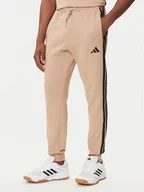 Spodnie sportowe męskie - adidas Spodnie dresowe Essentials 3-Stripes JX0712 Beżowy Regular Fit - miniaturka - grafika 1
