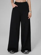 Spodnie sportowe damskie - 4F Spodnie dresowe z szerokimi nogawkami damskie - czarne XS - miniaturka - grafika 1