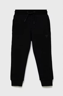 Spodnie damskie - Guess spodnie dziecięce kolor czarny gładkie - grafika 1
