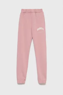 Spodnie damskie - Guess spodnie dresowe bawełniane dziecięce kolor różowy gładkie - grafika 1