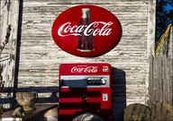 Plakaty - A vintage Coca-Cola sign and Coke machine outside the John E., Carol Highsmith - plakat 70x50 cm - miniaturka - grafika 1