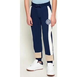 Guess Spodnie dresowe Regular Fit - Spodnie i spodenki dla dziewczynek - miniaturka - grafika 1