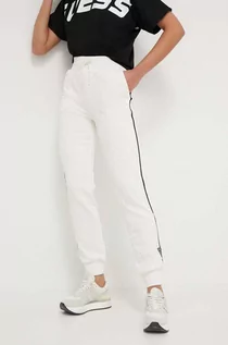 Spodnie damskie - Guess spodnie dresowe kolor beżowy z aplikacją - grafika 1