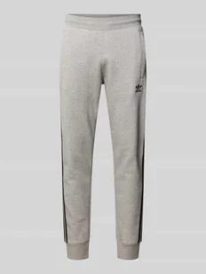Spodnie dresowe z elastycznym ściągaczem - Spodnie sportowe męskie - miniaturka - grafika 1