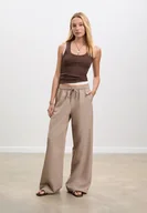 Spodnie damskie - Stradivarius Eleganckie długie zwiewne spodnie Szary L - miniaturka - grafika 1