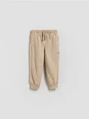 Spodenki dla niemowląt - Reserved - Bawełniane spodnie jogger - beżowy - miniaturka - grafika 1