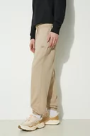 Spodnie męskie - New Balance spodnie dresowe bawełniane kolor beżowy gładkie - miniaturka - grafika 1