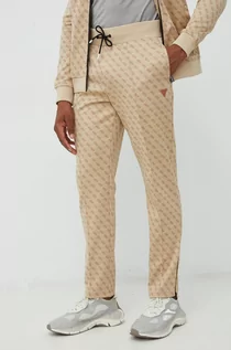 Spodnie męskie - Guess spodnie dresowe męskie kolor beżowy wzorzyste - grafika 1