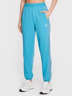 Spodnie sportowe damskie - adidas Spodnie dresowe adicolor Classics HC4578 Niebieski Relaxed Fit - grafika 1