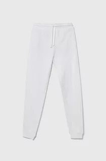Spodnie i spodenki dla dziewczynek - United Colors of Benetton spodnie dresowe bawełniane dziecięce kolor biały gładkie - grafika 1