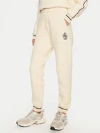 Spodnie sportowe damskie - Guess Spodnie dresowe Nia V4BB06 KCHU1 Beżowy Regular Fit - miniaturka - grafika 1