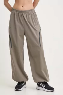 Spodnie damskie - Under Armour spodnie treningowe Unstoppable kolor brązowy szerokie high waist - grafika 1