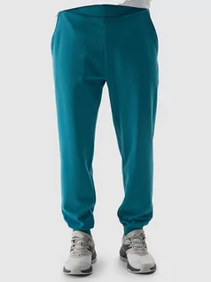 Spodnie sportowe męskie - 4F Spodnie dresowe w kolorze turkusowym - grafika 1