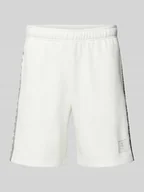 Spodnie sportowe męskie - Szorty z dzianiny dresowej o kroju tapered fit z nadrukiem z logo - miniaturka - grafika 1