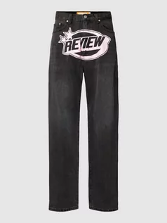 Spodnie męskie - Jeansy z nadrukiem z logo - grafika 1