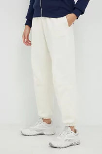Spodnie damskie - New Balance spodnie dresowe bawełniane damskie kolor beżowy gładkie - grafika 1